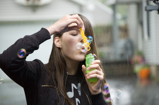 Blowing bubbles in the rain